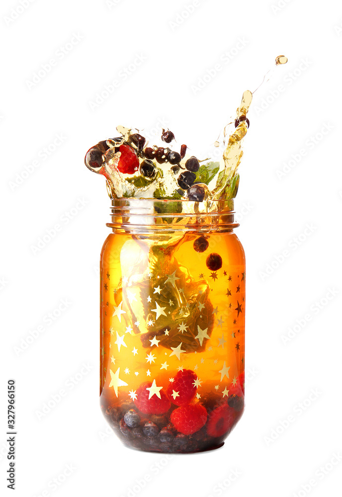 Mason jar of cold tea with splashes on white background
