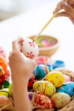Asian Young Pretty Woman Enjoy Painting A Water Colors On Fantasy Eggs For Easter Egg Festival. Beautiful Colorful Fancy Easter Egg In Bucket. The Symbolic Of Easter Egg Festival Concept.