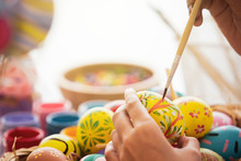 Asian Young Pretty Woman Enjoy Painting A Water Colors On Fantasy Eggs For Easter Egg Festival. Beautiful Colorful Fancy Easter Egg In Bucket. The Symbolic Of Easter Egg Festival Concept.
