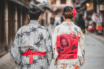  Young women wearing traditional Japanese Kimono with colorful maple trees in autumn is famous in autumn color leaves and cherry blossom in spring, Kyoto, Japan.