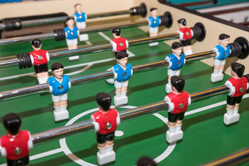 Wall Mural - Vintage Foosball, Blue and Red Players Team in Table Soccer or Football Kicker Game, Selective Focus. table game. Boy toy sport game concept. Soccer table is relax activities indoor for kid and family