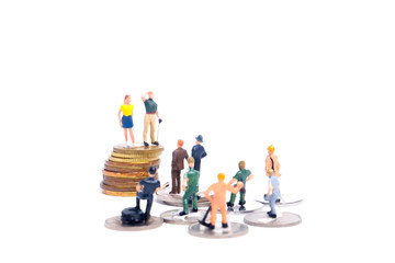 Selective focus picture of CEO and lower level employee miniature insight for job and income discrimination concept.