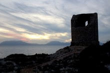 Evocative Image Of Pirate Watchtower On The Sea With Sea Coast In The Background