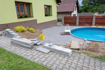 Swimming pool under construction, replacing interlocking pavement in rural country house