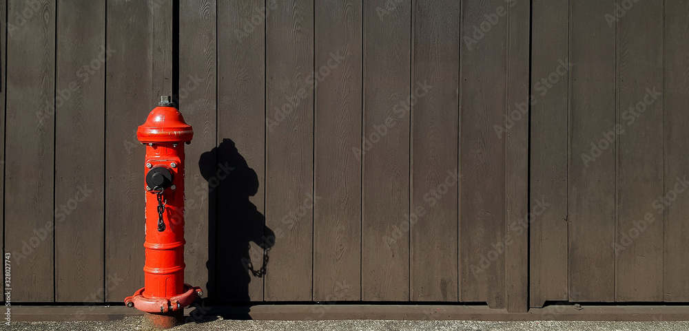 Red fire hydrant installed on sidewalk, street or road with shadow on ...
