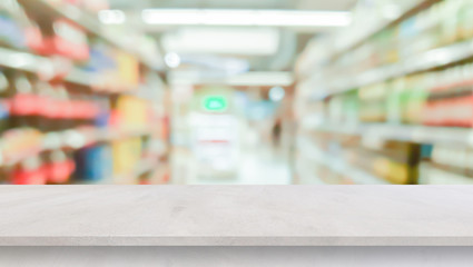 blur local supermarket convenience store background with cement perspective tabletop to showing product or ads banner and promote marketing on display concept	