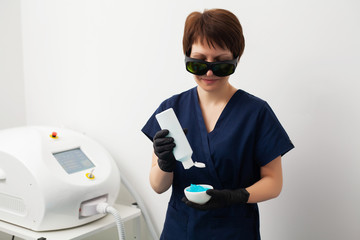 Wall Mural - Woman getting laser treatment in a beauty salon.