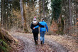 © Juergen - Two girls embraced, walking along a path in the forest in autumn or early spring