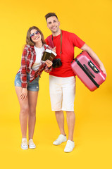 Sticker - Couple of tourists with luggage on color background