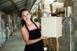 © JackF - Happy female seller holding box in warehouse