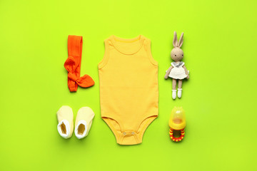 Wall Mural - Baby clothes and accessories on color background