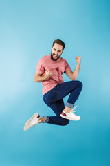 Wall Mural - Portrait of a young cheerful bearded man wearing t-shirt