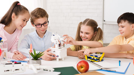 Poster - Smart school children touching diy robot at stem lesson