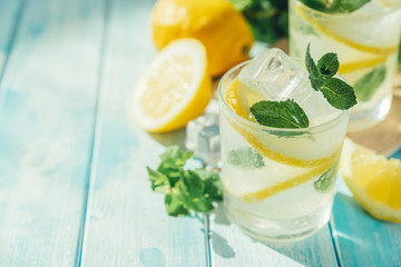 Wall Mural - Lemonade and ingredients on blue wood background, copy space