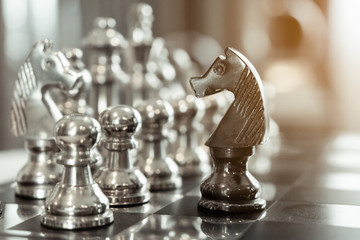 Wall Mural - Close-up horse leader of chess game over the chessboard, Chess game strategic business leadership successful teamwork. business leader concept.