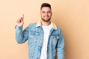 Russian handsome man over isolated background pointing up a great idea