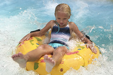 Little Girl On Water Slide At Aquapark.