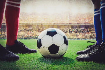 Wall Mural - feet of soccer players kick off in the stadium match