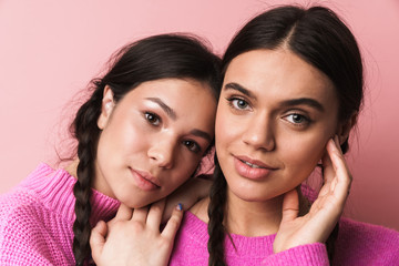 Wall Mural - Image of two attractive teenage girls with braids looking at camera