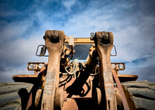 Front Detail Of An Old Abandoned Yellow Tractor In A Marble Quarry