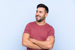 © luismolinero - Young handsome man with beard over isolated blue background happy and smiling