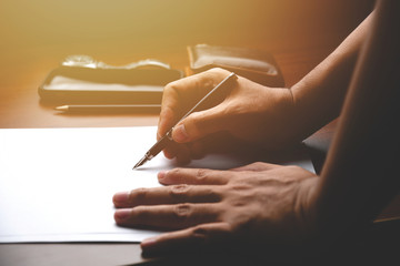 Poster - Male manager putting his ideas and writing business plan at workplace. man holding pencil making notes in paper documents on the table in office