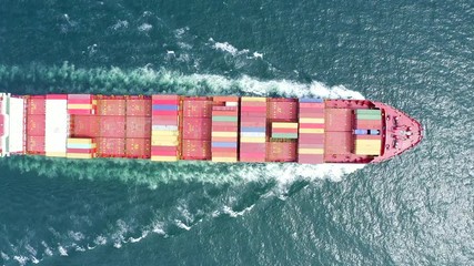 Wall Mural - Top view of a cargo ship sailing at sea