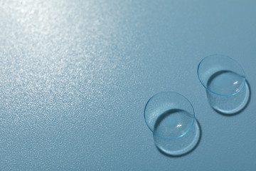 Sticker - Contact lenses on blue background, space for text