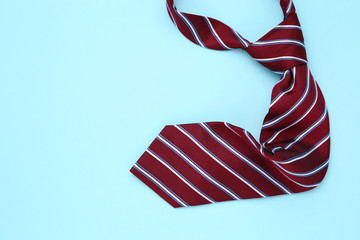 Striped necktie on blue background