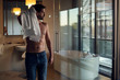 © PhotoAlto - Young man drying hair with towel while standing in bathroom