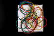 © NAIL BATTALOV - Close-up colorful rubber band on white background..