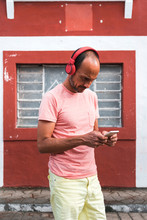 Male Tourist Listening To Music On Street