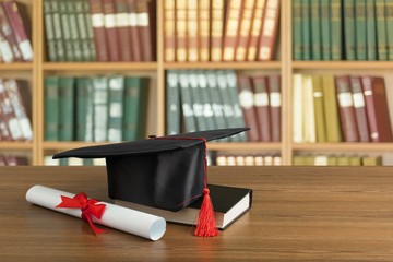 Wall Mural - Graduation hat, book and diploma on wooden table