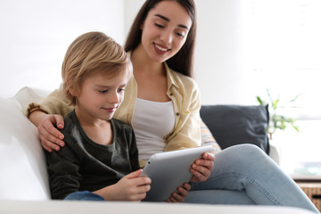 Poster - Mother and son reading E-book together at home