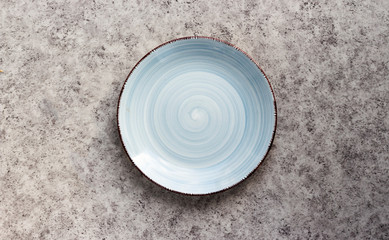 Wall Mural - Empty ceramic blue plates on a grey background.