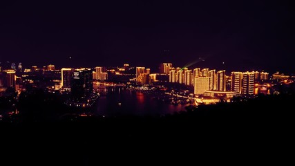Poster - drone flying above city at night light illuminated buildings river with yachts
