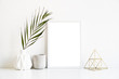 © Daria Minaeva - White frame and home decoration details on tabletop with wall, artwork poster mock-up