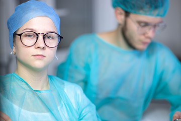 male and young girl, doctor and intern assistant in a medical office.