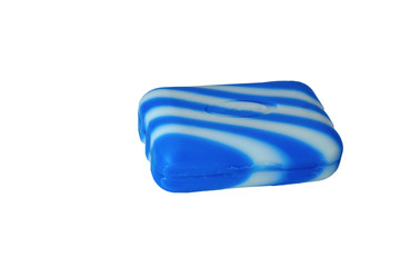 A piece of soap in blue and white isolate on a white background. Close-up.