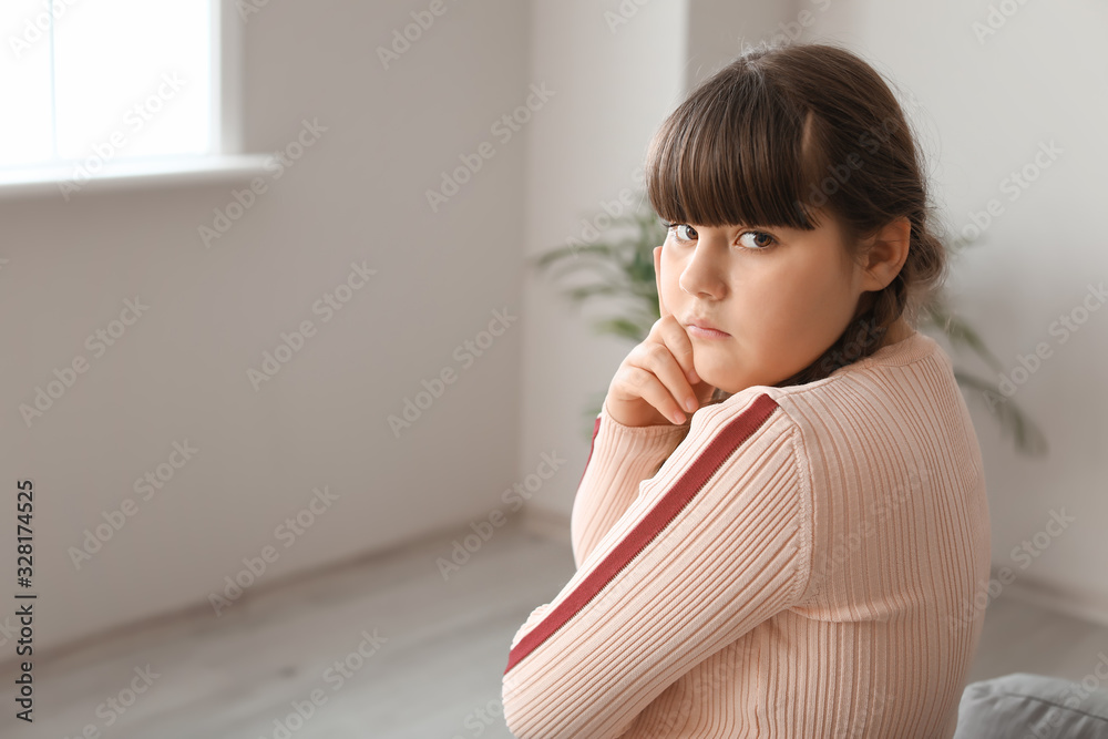 Sad overweight girl at home