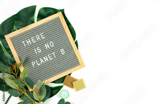 Pro environment letter board concept with There is No Planet B message and environmentally friendly zero waste shopping bag with household products. Negative copy space.