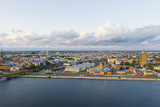 Fototapeta Uliczki - Aerial view photo from flying drone panoramic view of Riga's bridges, the Daugava River, the TV Tower and the city skyline on a sunny summer day in Riga, Latvia. (series)