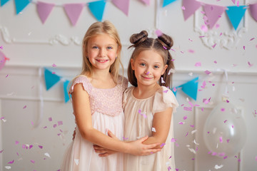 Wall Mural - Happy birthday Happy cute children in festive decor and beautiful dresses play with confetti.