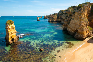 Wall Mural - bright sunny view of the rugged atlantic coastline of the algarve at dona ana beach near lagos, port