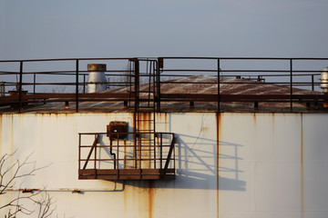 Huge industrial storage tank with stairs. old rusty tank.