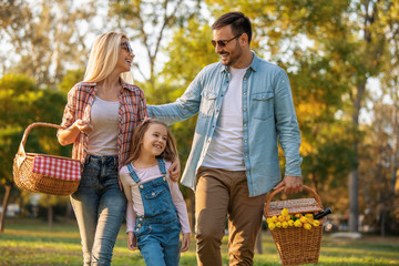 Cheerful family enjoying picnic in nature