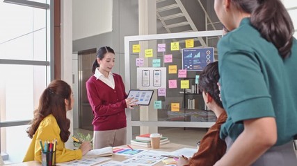 Asian businesswoman leading creative developer team in application development presentation meeting, mobile app software design project. Business technology, office people teamwork concept. 4K panning