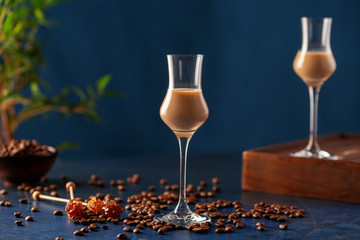 Wall Mural - Irish cream or Coffee Liqueur and coffee beans on blue background