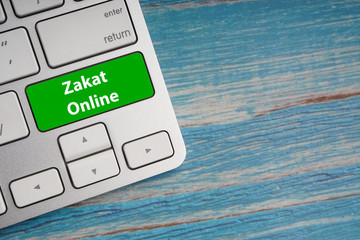 Sticker - ZAKAT ONLINE text on button of computer keyboard. Business and Islamic concept