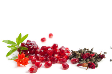 Canvas Print - Parts of a pomegranate with pomegranate seeds and leaves, flowers, dry green tea with carcade  isolated on white background